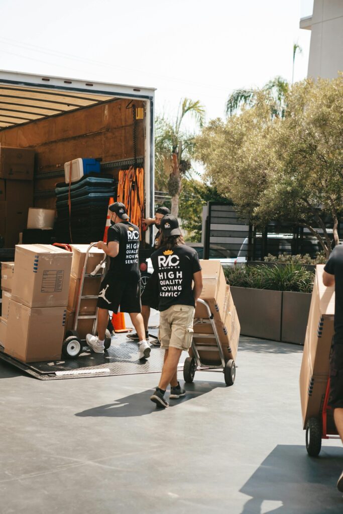 Man Carrying Boxes on Trolleys